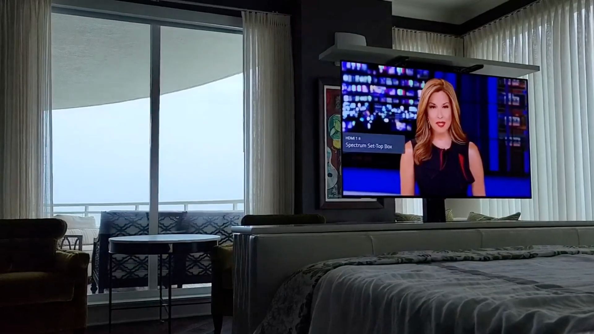 Condo bedroom with motorized TV installation by Entertainment Pros